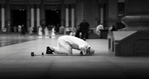 Someone is prostrating during the prayer. 