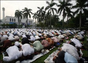 Some Muslims are performing prostration during the prayer.