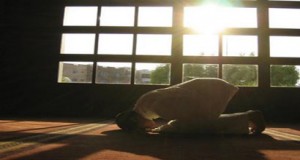 A person is prostrating during prayer.