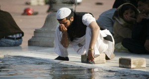 A person performing ablution for the prayer