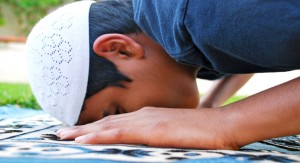 A young boy is offering prayer.