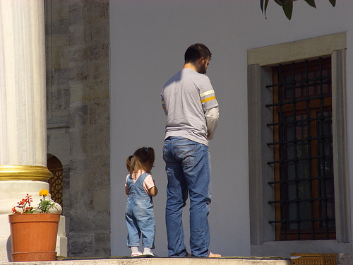 A man and his little daughter offer prayer.